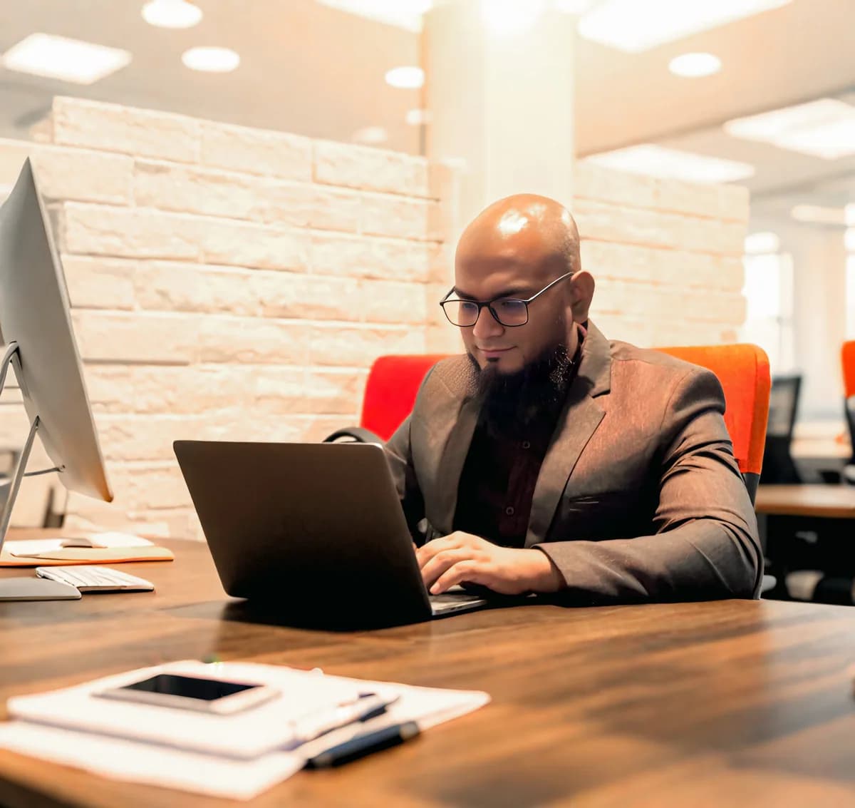 A Square Tech IT team member working at a laptop in the studio